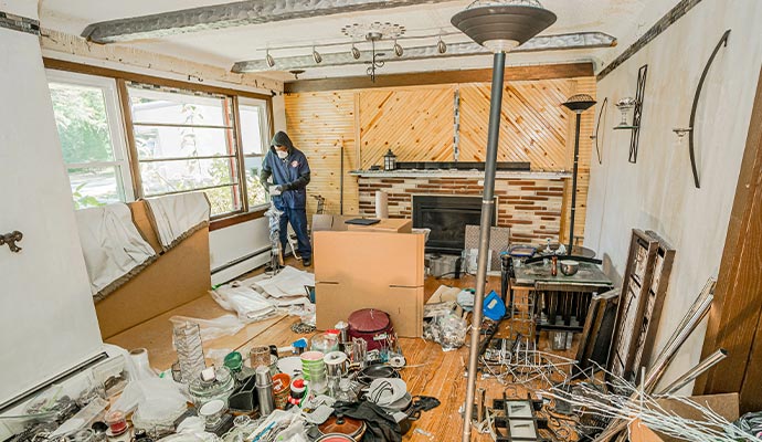Hoarding cleanup service Person cleaning up a hoarded room