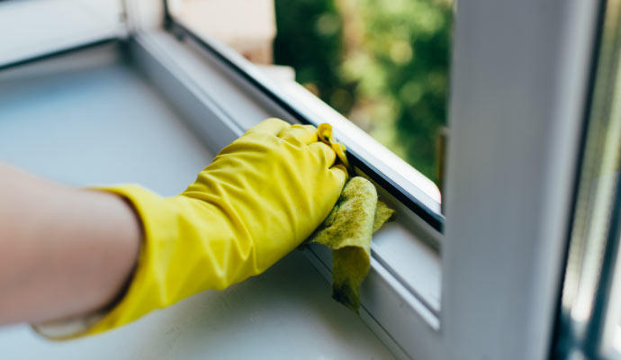 Person cleaning window after construction