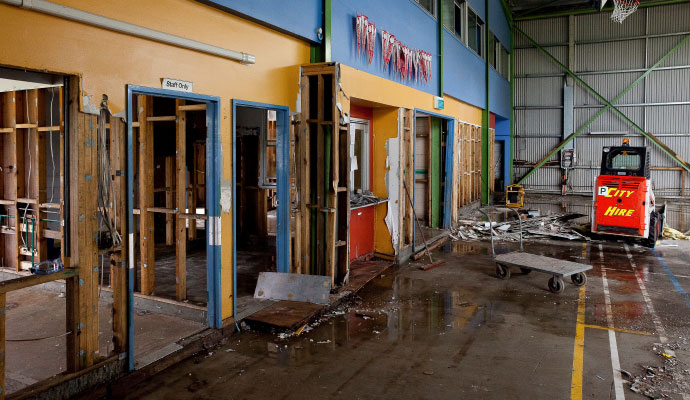 Professional worker inspecting flood damaged property